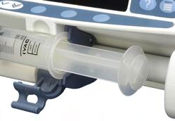 3. Insert the syringe ensuring that the barrel flange is located in the slots on the syringe flange clamp.