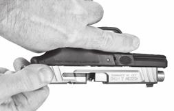 Keep the muzzle still pointed in a safe direction, and keep your finger off the trigger and outside the trigger guard, grasp the serrated sides of the slide from