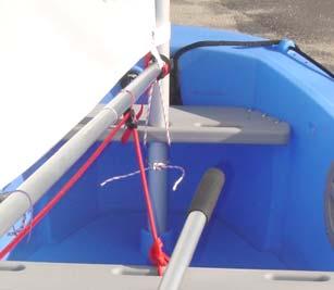 Step G. Install the Mast in the Boat and Snap Boom to Mast 1. Pick up the mast with attached gaff, boom and sail, and drop the bottom of the mast through the hole in the front seat. 2.