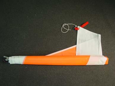 5. Roll the sail as snugly as possible around the mast, gaff, and boom (which are pressed up against each other).