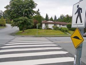 Raised crossings can be distinguished from the street through a variety of painted markings or surface treatments.