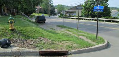 Nonetheless, there are sidewalk gaps on some blocks and pedestrians have worn paths in the grass where sidewalks are lacking.