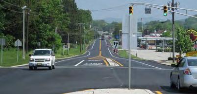 Sidewalk connects Washington Avenue and Franklin Elementary School to shopping and restaurant destinations along Route 23. Paved shoulder acts as a bike lane.