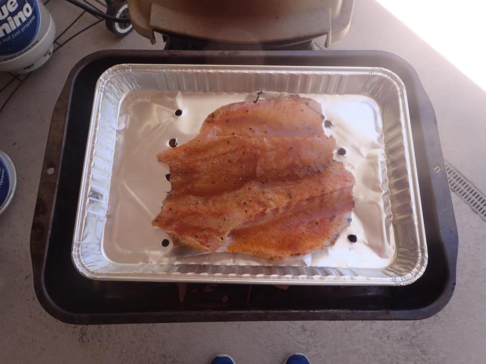 Smoked Fish on the Grill This is a simple way to smoke fish on your grill. You need an old baking pan and a smaller aluminum pan with holes in the bottom.