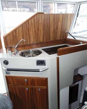 Beneath the aft end of the berth the mattress lifts to access a storage compartment, and under the forward end of the berth another panel provides access to the bilge.