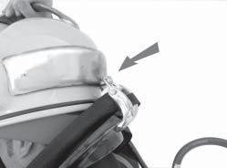 Slide the tab over the sleeve. Fig. 2.15 Lift the helmet over your head. Tender - Pull the strap down and back towards the divers right until it is snug, but comfortable.