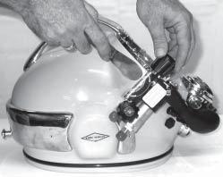 Run the stud nut (98) down the stud and tighten with torque wrench (20 inch pounds). DO NOT OVERTIGHTEN. Fig. 6.9 Use a putty knife to separate the block from the helmet shell.