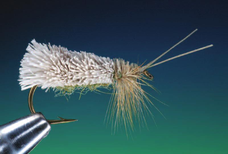 16. Wind on the hackles one at a time. First, the rear hackle should be wound a couple of turns backwards into the deer hair body and then forwards to the hook eye and tied off.
