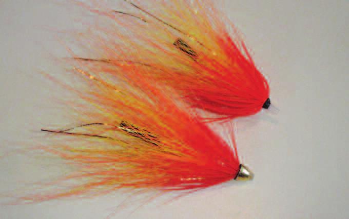 6 7 6. Attach the gold flash on top of the tube. Then tie in the orange bucktail in the same way as in Step 4.