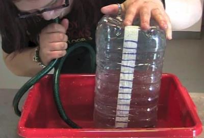 Lessons 1 and 2: Aspirator 1. Attach a strip of tape to the 5l bottle from top to bottom. 2. Use the measuring cylinder to add 250 ml of coloured water to the bottle.