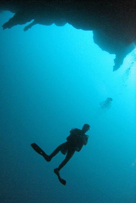 Diver Rob Greene after diving at Half Moon Caye, site of the famed Great. A diver descends to 140 feet (43m) below sea level at the Great.
