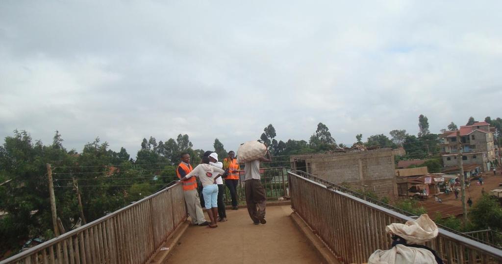 Picture 35: Pedestrian carrying a bag of Irish potatoes while crossing the footbridge Source: Author, 2013 Picture 36: Female pedestrians