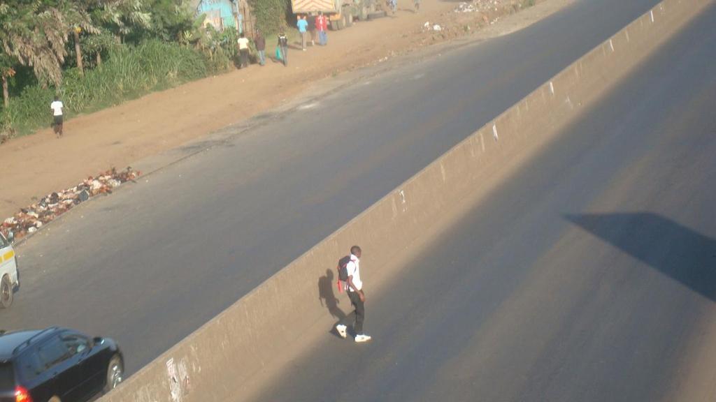 Picture 22: Student crossing highway by jumping over barrier Source: Author, 2013