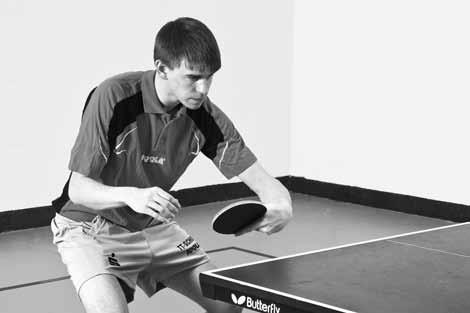 Table Tennis: Steps to Success triangle as discussed in step 2 (page 19). The backswing is very short, bringing the racket back toward the body about parallel to the end line of the table.