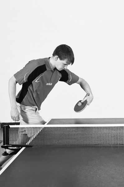 Table Tennis: Steps to Success Figure 10.3 Contact with racket moving away from the body during the forehand double-motion serve, left-handed player.