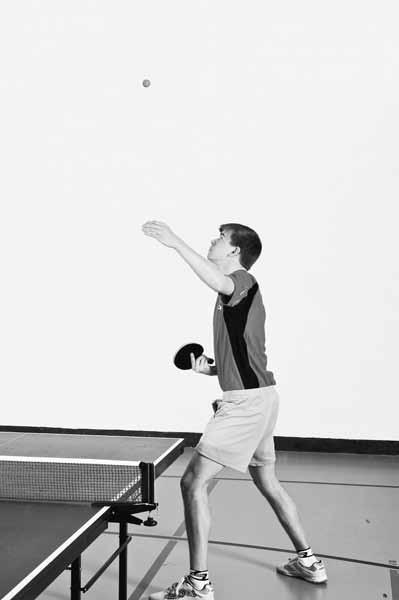 Figure 10.4 High-Toss Forehand Left Sidespin Serve a b Beginning Position 1. Stand outside left side line 2. Left foot slightly in front of right foot 3. Upper body parallel to side line 4.