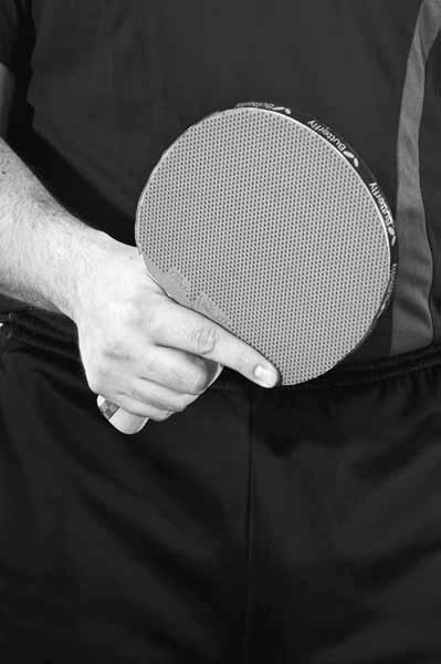 This grip supports strong forehand strokes, but puts the racket in a weak position for the backhand. Figure 1.4 Strong forehand grip. Misstep The forefinger is up the middle of the blade.