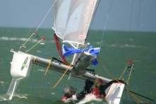 This can be done from the underside of the boat but care must be taken not to catch the spinnaker as it is being retrieved. It is essential for righting the boat to point the mast into the wind.