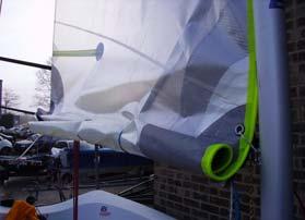 5. Roll the excess mainsail and tie it to the boom using sail ties through the reefing eyes.