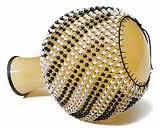 Shekere a dried hollow gourd with beads woven into a net covering the gourd. The shekere originated in Nigeria and is used throughout West Africa in drum ensemble music.