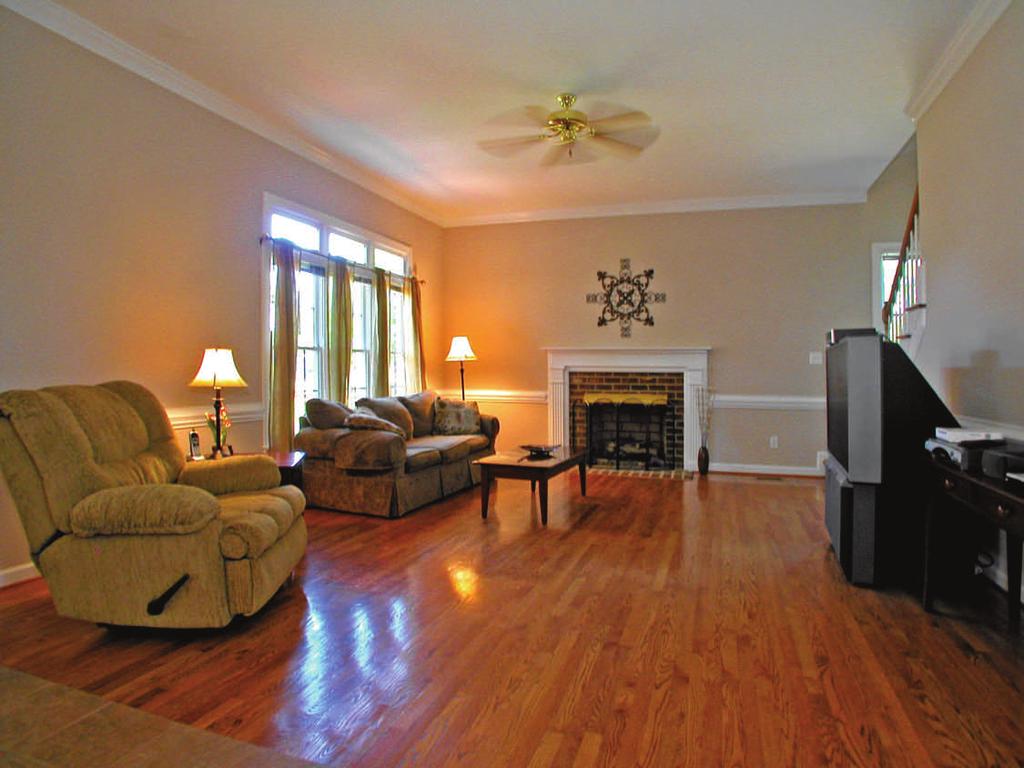 The spacious great room is open to the kitchen and features: Beautiful hardwood floors Triple, French-style framed
