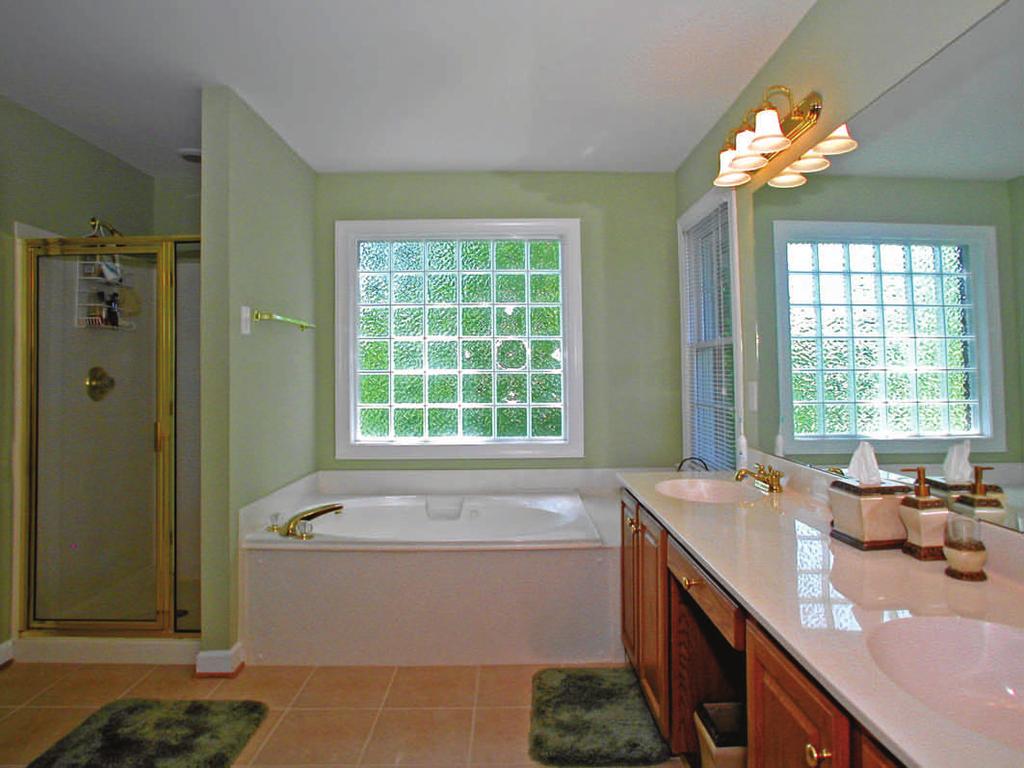 En-suite bathroom Large, spa-like master bathroom features: Whirlpool garden tub flanked by two windows