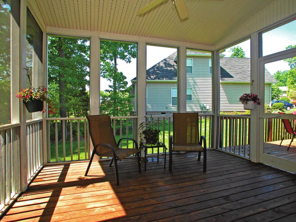 Custom-built screened porch with ceiling fan is a wonderful spot to