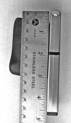 8.6.2.3 Cover 2 (50.8 mm) of the magazine as measured from the top of the cartridge rim down the back flat of the magazine tube. 8.6.2.4 Cover the entire outer face of the portion of the magazine inside the carrier.