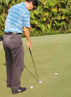 They may point a line for putting only BEFORE the player makes the stroke but the surface must not be touched.