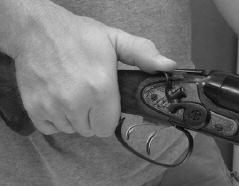 While keeping your fingers away from the triggers, grab the shotgun firmly with your right hand around the stock s pistol grip.
