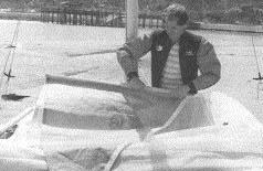 To lower the main on the Prindle 15 and 18, hoist the mainsail up as far as possible and rotate mast away from sail to unhook main halyard.