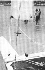 Using the main halyard as a plumb, measure the distance from the aft edge of the mast at the black band to the center of the plumb. This distance is how much mast rake you have.