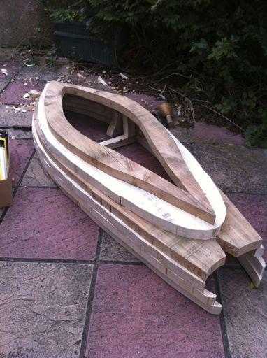 (a) Rough hull assembled from the sections (b) Initial fairing of sections (c) Planing and sanding the hull Figure