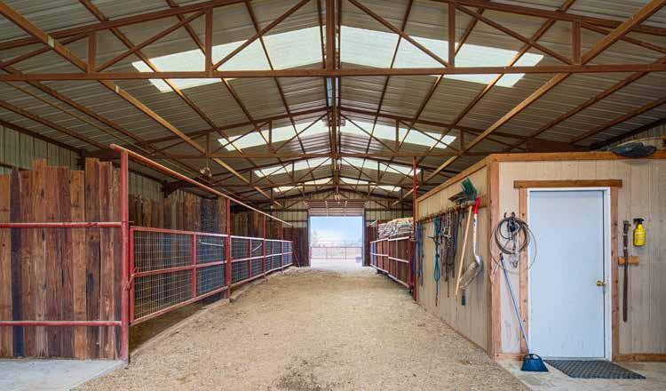 The Wild Card Horse Ranch horse barn is all steel frame construction with metal siding and roof with skylights.