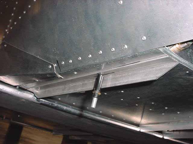 Locate the rivet through the front and rear flange of the TD Heel Support 6TD1-7 Drill and Cleco pilot holes for the AN3 bolts in the longeron and