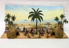 3 Palm Trees, 2 Kraals, and 6 Zulus with Reproduction Backdrop. 11 Pieces. Condition Very Good.