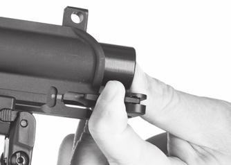 3. Reassemble the charging handle and bolt carrier into the upper receiver: a. Turn the upper receiver upside down so that the top of the rifle is pointing toward the ground.