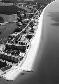 At Bonita Beach, Florida, in September 1995, a pair of traditional rock groins was used to stabilize the downdrift end of a 190,000 m 3 beach fill updrift of a small tidal inlet and to promote a