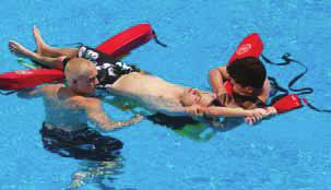 2 The primary rescuer moves the victim to the side, if possible, toward a corner. An assisting lifeguard places a rescue tube under the victim s knees to raise the legs.