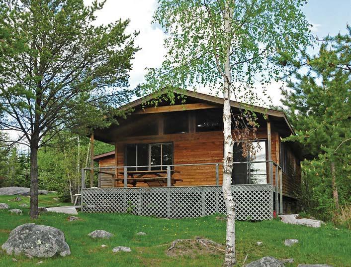 The picture-perfect four-bedroom cabin here is built among the pines on a rocky point overlooking the bay.