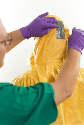 The PPE user can hold up the coveralls to avoid pressure on sensitive body areas and facilitate sealing the flaps.