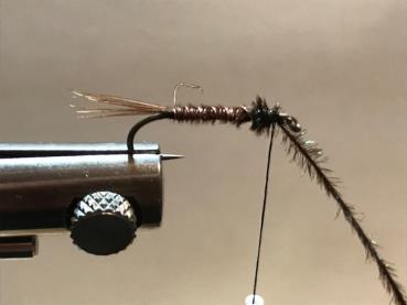Step 4: Next counter wrap the wire forward to reinforce and further secure the pheasant tail body and tie it off there. Trim the excess barbules, and helicopter the wire off.