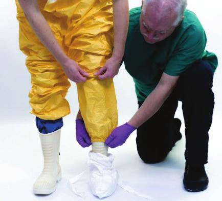 Safe use of PPE in the treatment of infectious diseases of high consequence TECHNICAL DOCUMENT Pull up the trousers before attaching them to the widest part of the calves.