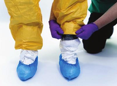 TECHNICAL DOCUMENT Safe use of PPE in the treatment of infectious diseases of high consequence Fold the slack of the coverall leg to cover the part of the taping.