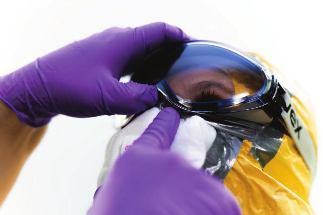 Cover all possible gaps between goggles, respirator and the hood with tape and make sure that the tape is properly stuck to the hood.