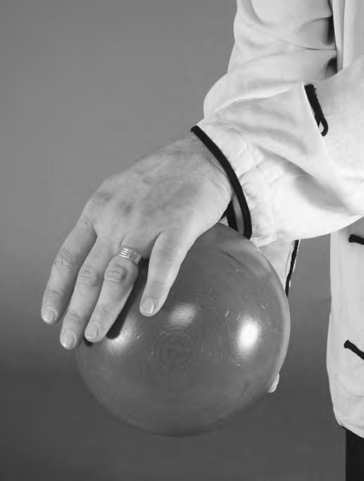 As you continue this movement, you should start with your palm facing away from the ball; then roll the ball forward and coil your palm over to face the ball.