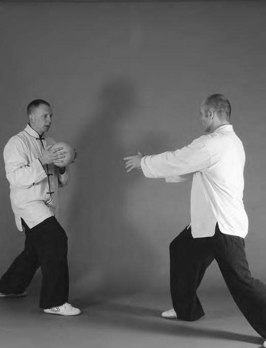 Practicing these movements with your taiji ball will help you focus on twisting the waist as well as demonstrate a compact, rounded feeling for your postures. Figure 6-64 