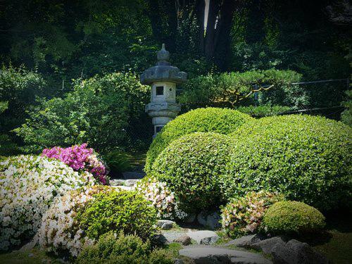 This style of garden invites visitors to follow a winding path along a central pond.
