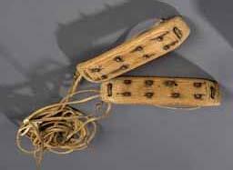 Item number: Fry0205 Item Number: Fry0205 Category: Crampons Period: 1900-1925 Materials: Wood, iron, seal hide lashings Description: Crampons, made to be tied to the bottom of Eskimo boots, for aid