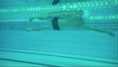his side because he has a strong kick. I recommend rotating about half as much for most swimmers.
